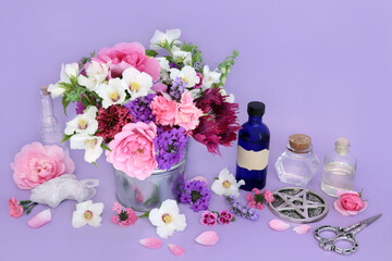 Flowers and herbs preparation for herbal remedies. Flower essences with quartz crystal for alternative medicine on lilac background. Wicca occult natural medicinal healing concept. - 782454523