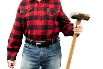 an unidentifiable worker in a red and black plaid shirt holds a large sledge hammer isolated on...
