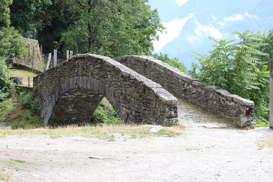 Old Roman Bridge near Santa Petronilla waterfalls in Biasca, Ticino, Switzerland 
