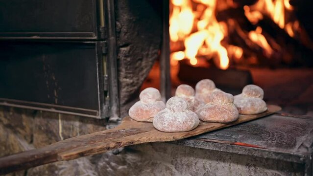 "Shecas" traditional guatemalan bread from quetzaltenango, coming out of a hot artisanal oven. the bread is cooked in a wood oven.