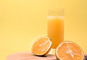 Juice with a straw in a glass. Summer drink orange. Soda in a transparent glass. Apperol alcoholic drink. Natural juice with ice. Multivitamin fresh squeezed.
