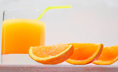 Juice with a straw in a glass. Summer orange drink with orange slices. Soda in a transparent glass. Apperol alcoholic drink. Natural juice with ice. Multivitamin fresh squeezed.