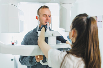 A young man underwent a CT scan of the jaw, a circular image of the jaw in modern dentistry. Radiology, panoramic scanner.