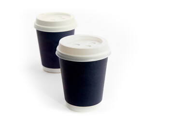 two dark blue paper cups of coffee with lids isolated on white