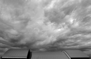 minimalist view of large roof under a very cloudy sky