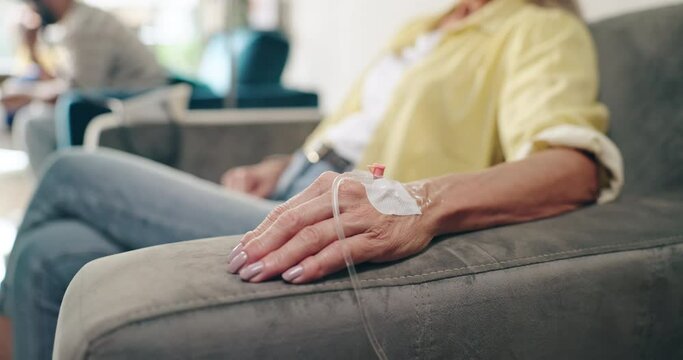Hands, healthcare and senior woman with iv drip in a hospital for cancer, treatment or chemotherapy. Catheter, fluid and elderly female patient at a wellness clinic for kidney dialysis treatment