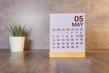 11 Mai on wooden grey cubes. Calendar cube date 11 May. Concept of date.