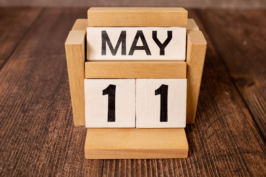 11 Mai on wooden grey cubes. Calendar cube date 11 May. Concept of date.