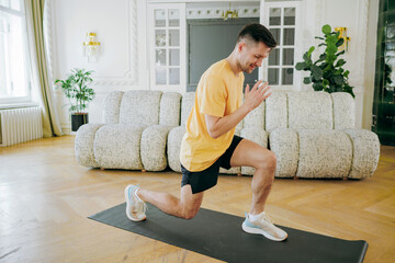 Man engaged in a dynamic lunge workout on a mat, fusing fitness and comfort in an elegant home...