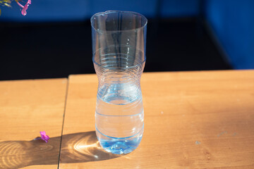 Cut plastic water bottle. Simple flower vase. Water in a plastic bottle.