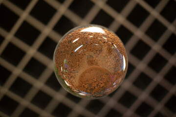 Item in the interior. Glass ball with sand. Decoration of space.