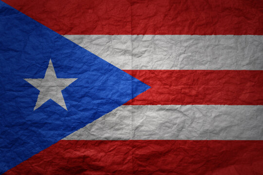 big national flag of puerto rico on a grunge old paper texture background