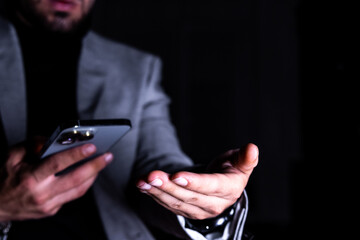 Businessman with smartphone gesturing touch technology