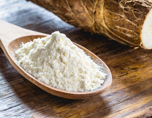 Fototapeta na wymiar Wooden spoon with manioc flour. Root used in Brazilian cuisine