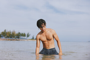 Active Asian Man Having Fun Swimming in the Tropical Blue Water on a Beach Vacation