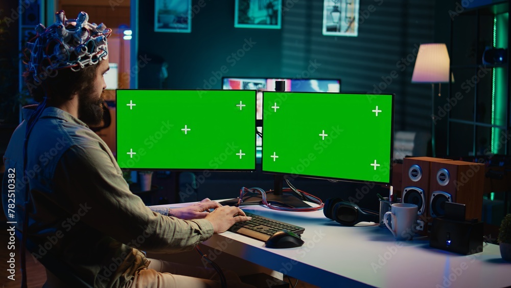 Poster computer engineer using eeg headset, starting mind upload process using green screen pc. man using n