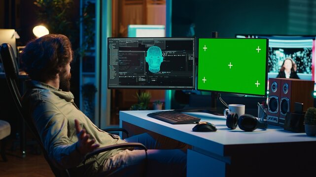 Programmer being asked existential questions by awaken AI on mockup PC gaining consciousness. Man communicating with artificial intelligence through green screen computer, camera A