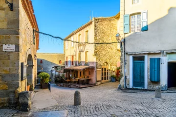 Wandcirkels plexiglas A picturesque street and alley of shops and sidewalk cafes in the La Cite' medieval old town inside the castle at Carcassonne, France. © Kirk Fisher