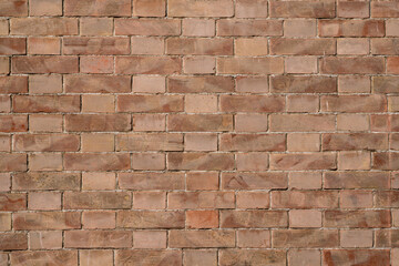 Brick wall textures create a pattern that extends horizontally and vertically along the wall. The shades of red, varied by time and wear, add depth and character to the composition.