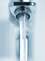 Water running from faucet closeup