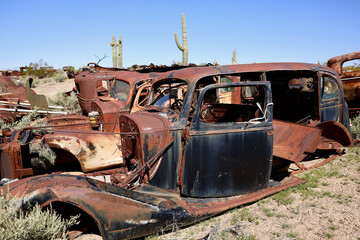 old rusty cars in the desert junkyard