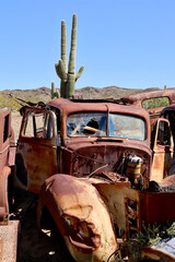abandoned rusty vehicle in a desert junkyard