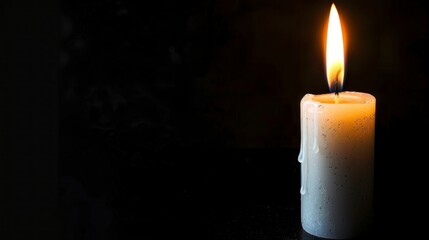 burning white candle in a dark room in high resolution