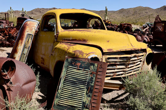 vintage collector pickup truck in a desert junkyard