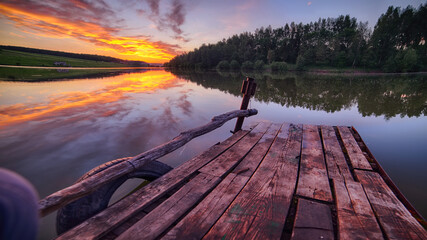 Amazing Wooden dock, pier, on a lake in the evening.