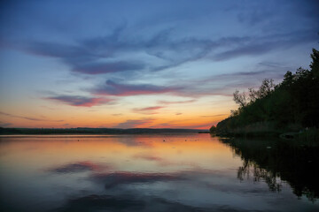 Amazing sunset over calm lake.