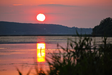 Amazing sunset over calm lake.