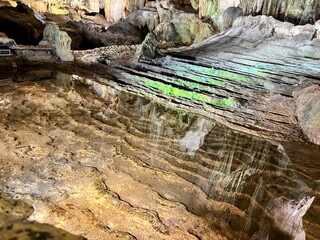 views of the fresh water next to the incredible stalacties and stalagmites inside Dau Go cave in Halong Vietnam