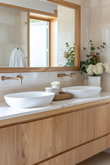 Fototapeta na wymiar A closeup of two white ceramic basins on top, set in an elegant oak wooden bathroom cabinet with brass faucet and warm beige tiles, complemented in the style of soft natural light from a large window