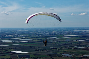 People enjoy the extreme sport of paragliding. Outdoor living in the blue sky. Incredible nature...