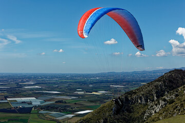 People enjoy the extreme sport of paragliding. Outdoor living in the blue sky. Incredible nature...