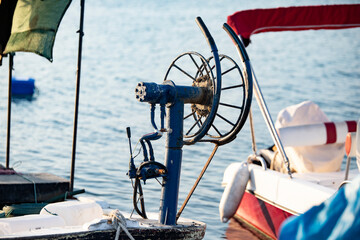 Fishing boat at sea at sunset. Reel on a fishing boat. Shallow depth of field. silhouette boat...