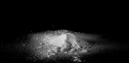 White powder isolated on black background, top view with clipping path	