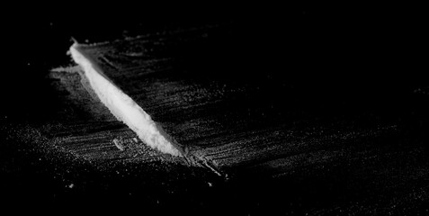 Cocaine line isolated on black baclground - obrazy, fototapety, plakaty