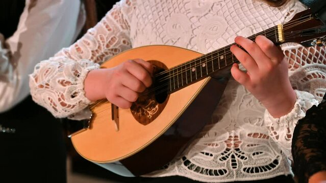 Close-up of a woman playing the mandolin
