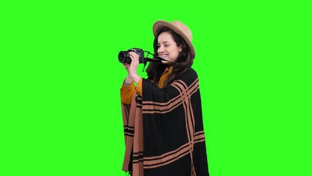 Smiling female photographer making photo for people on the chroma key