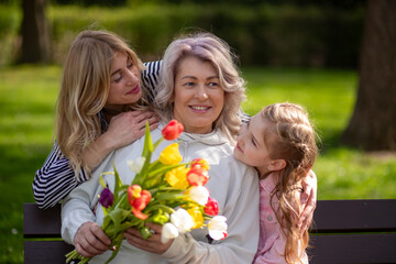 Three generations family with tulip bouquet
