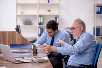 Two male colleagues working in the office