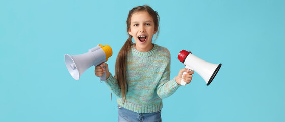 Little girl with megaphones on blue background