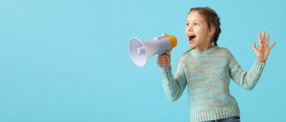 Little girl with megaphone screaming on blue background