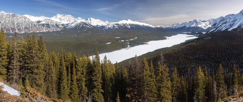 Scenic Early Springtime Landscape Panorama, Snow Covered Kananaskis Lakes, Pine Forest Valley, Rocky Mountain Peaks Skyline.  Peter Lougheed Alberta Provincial Park, Canadian Rocky Mountains