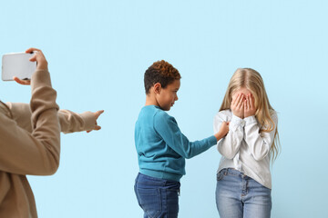 Pupils bullying little girl on blue background - obrazy, fototapety, plakaty