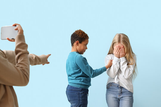 Pupils bullying little girl on blue background