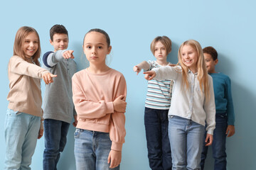 Bullied little girl and pupils on blue background - obrazy, fototapety, plakaty