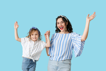 Happy pin-up woman and her daughter on blue background - obrazy, fototapety, plakaty