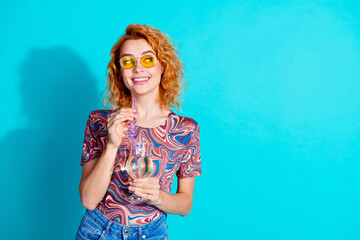 Portrait of nice lady hold cocktail look empty space wear t-shirt isolated on teal color background